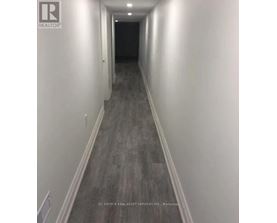 A long hallway with a light on the wall.
