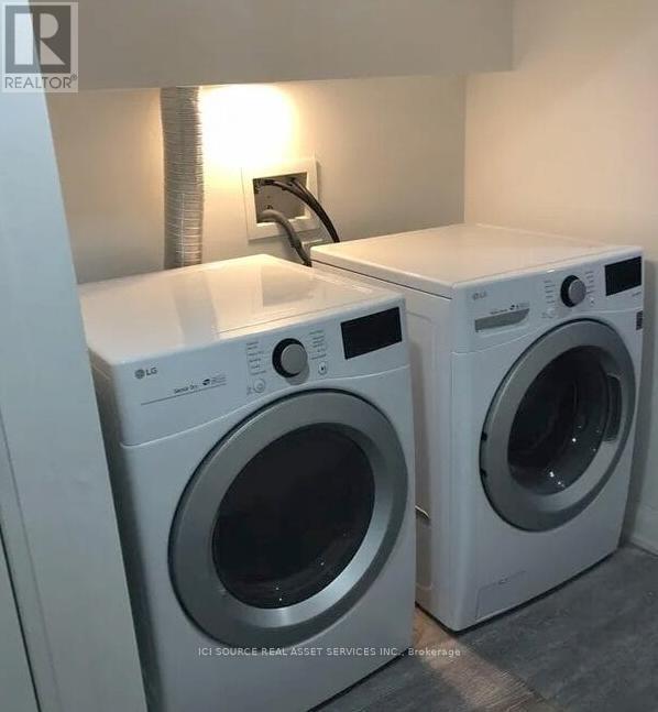 Two front load washing machines in a laundry room.