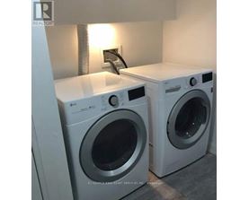 Two front load washing machines in a laundry room.