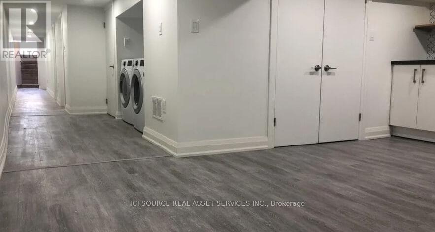 A laundry room with a washer and dryer in it.