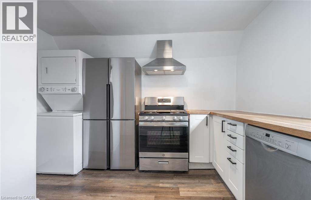 A modern kitchen with white appliances and wooden countertops.