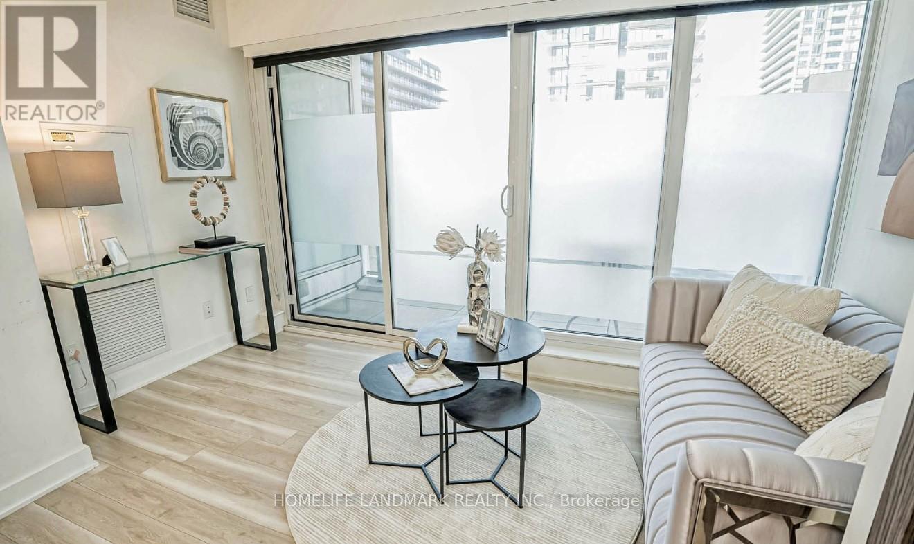 A living room with a glass door leading to a balcony.