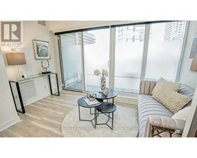 A living room with a glass door leading to a balcony.