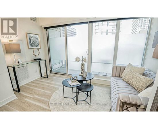 A living room with a glass door leading to a balcony.