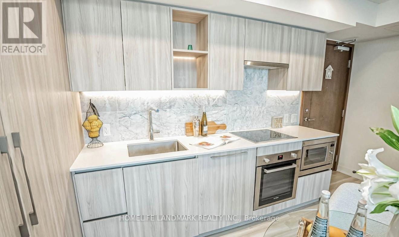 A modern kitchen with a marble backsplash and wooden cabinets.