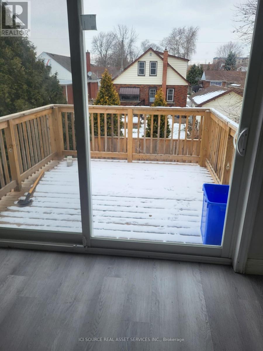 A view from inside a house looking out to a snow-covered deck.