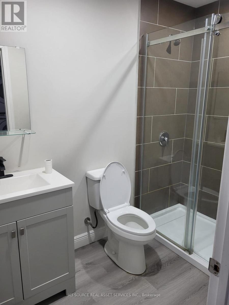A white toilet in a bathroom with a glass shower door.