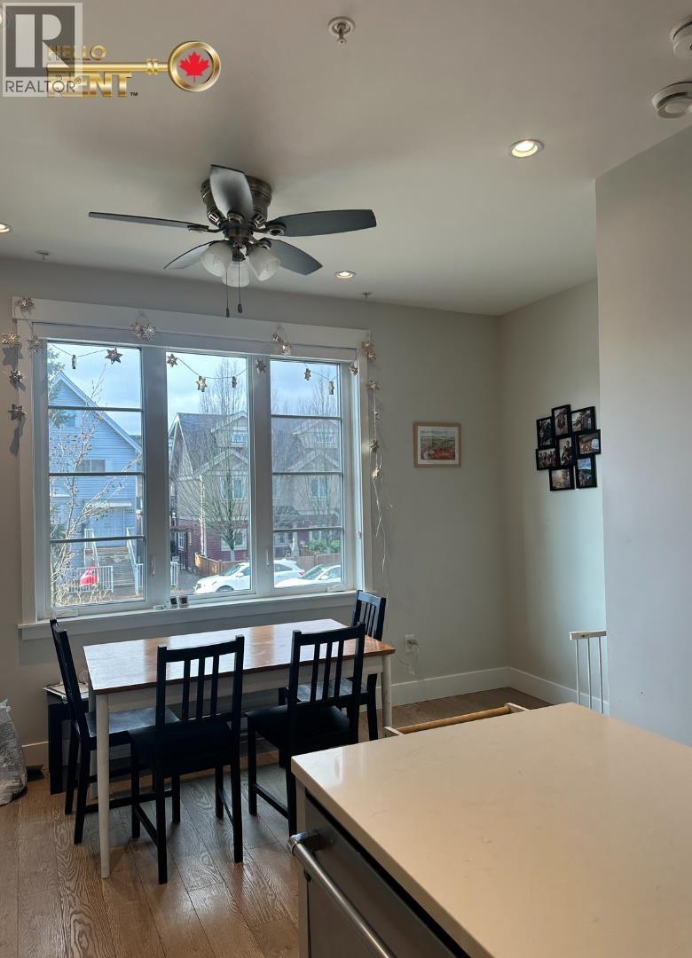 A dining room with a table and chairs.