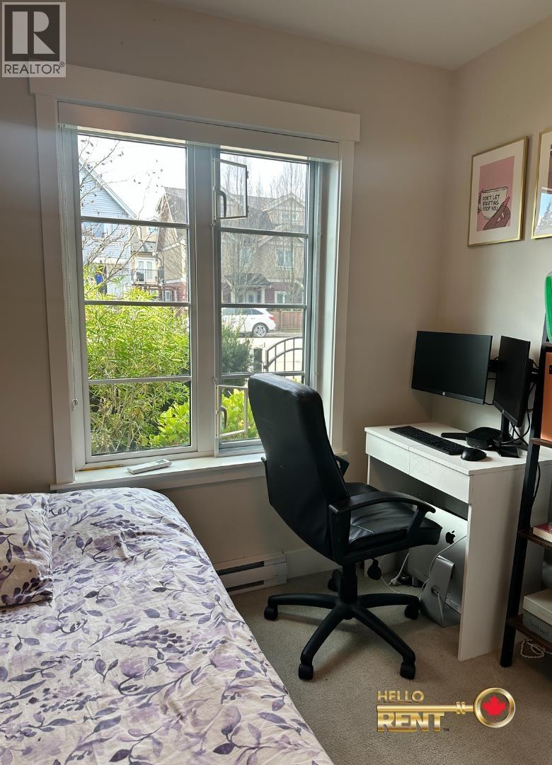 A bedroom with a bed, desk, and chair.