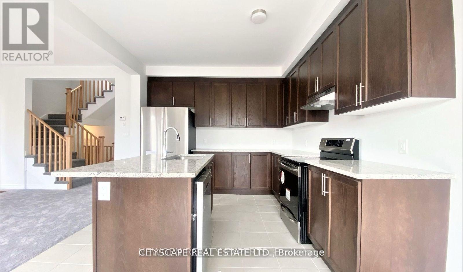 A kitchen with dark wood cabinets and a white countertop.