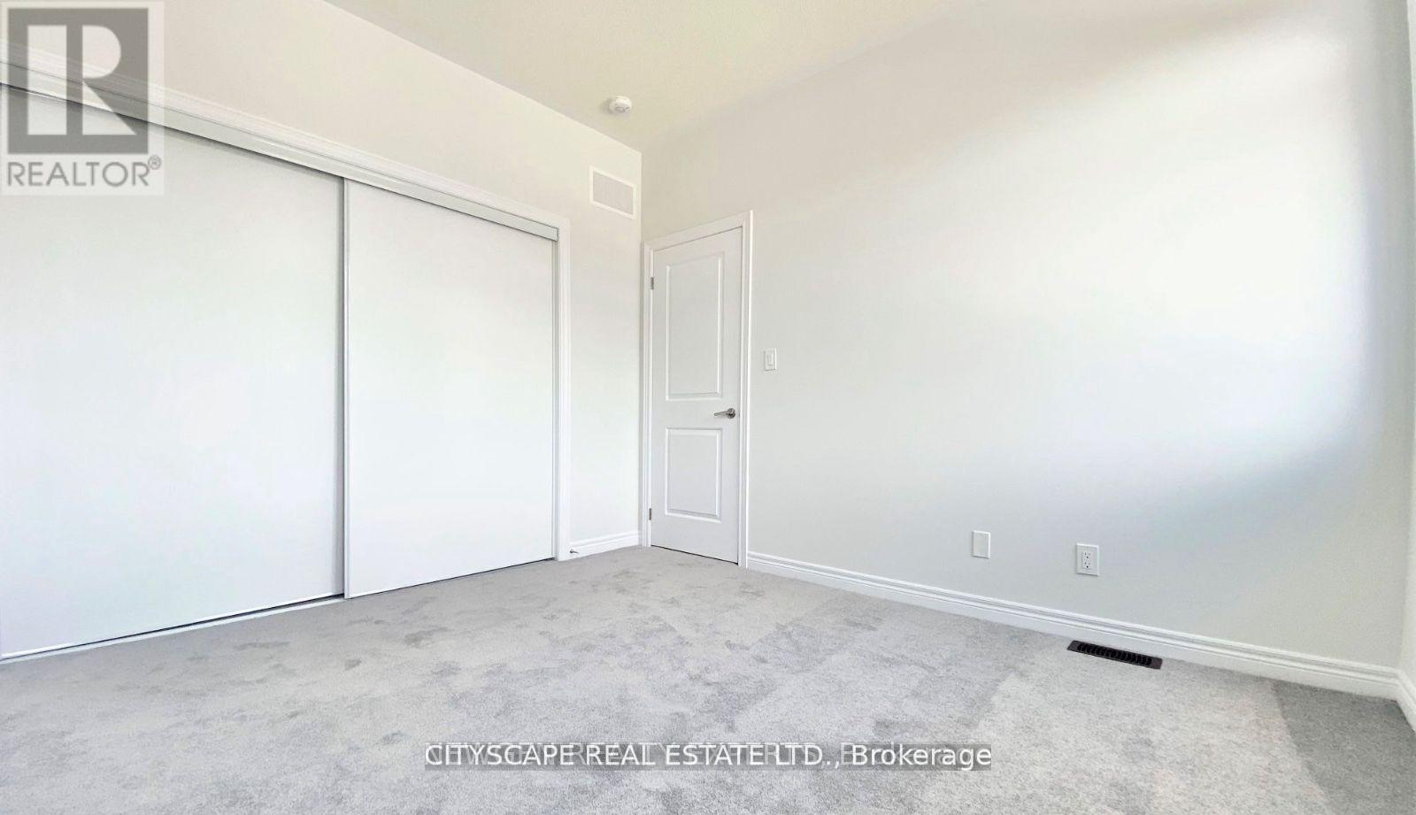 A room with a sliding door and a white door.