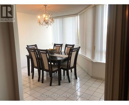 A dining room with a table set for six.