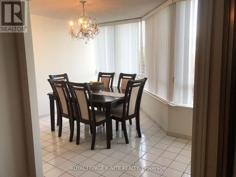 A dining room with a table set for six.