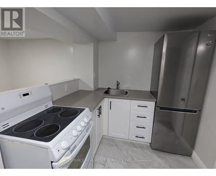 A kitchen with white appliances and cabinets.