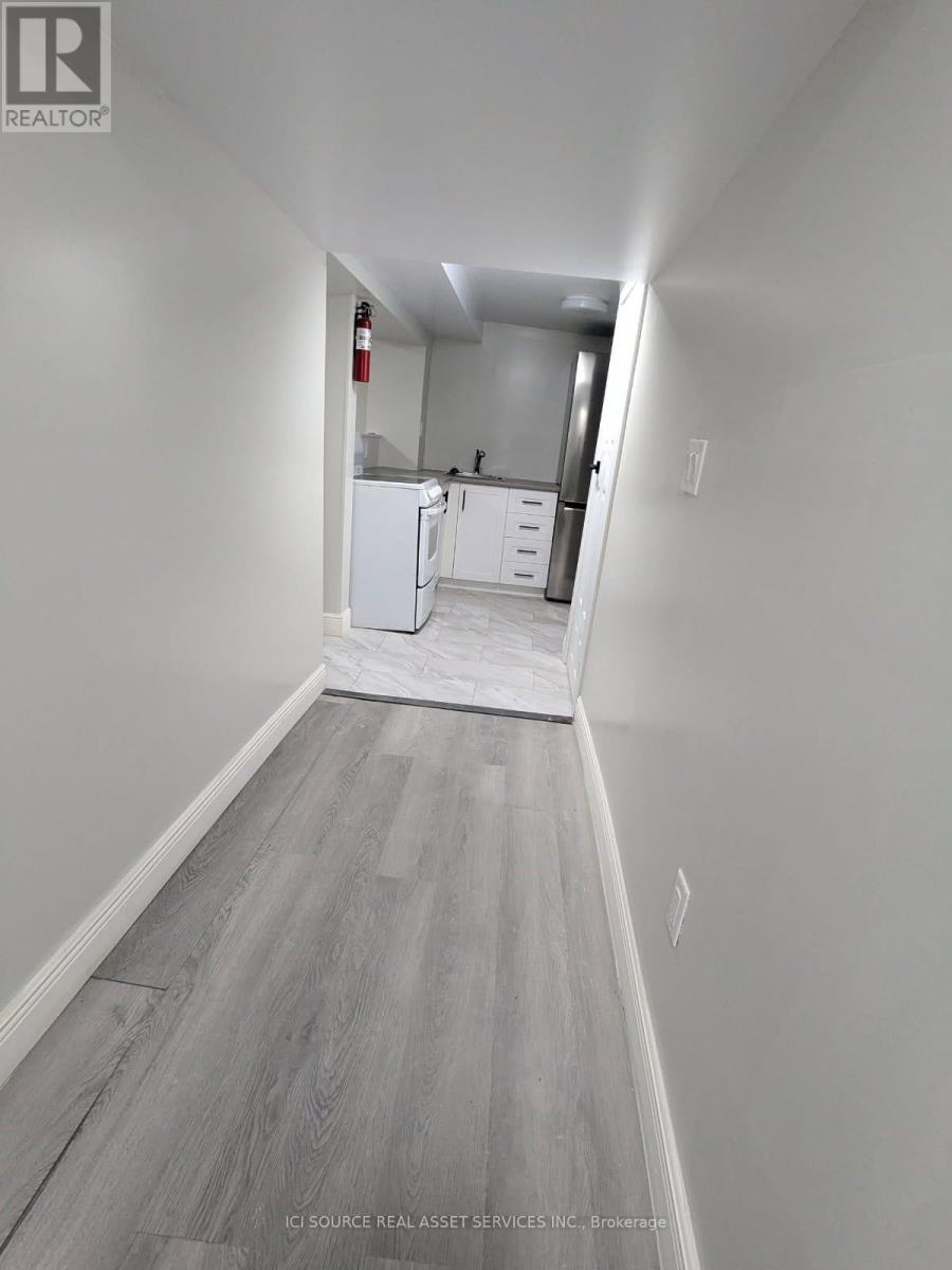 A long hallway with a kitchen in the distance.