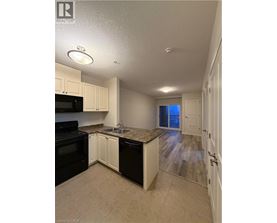 A kitchen with black appliances and white cabinets.