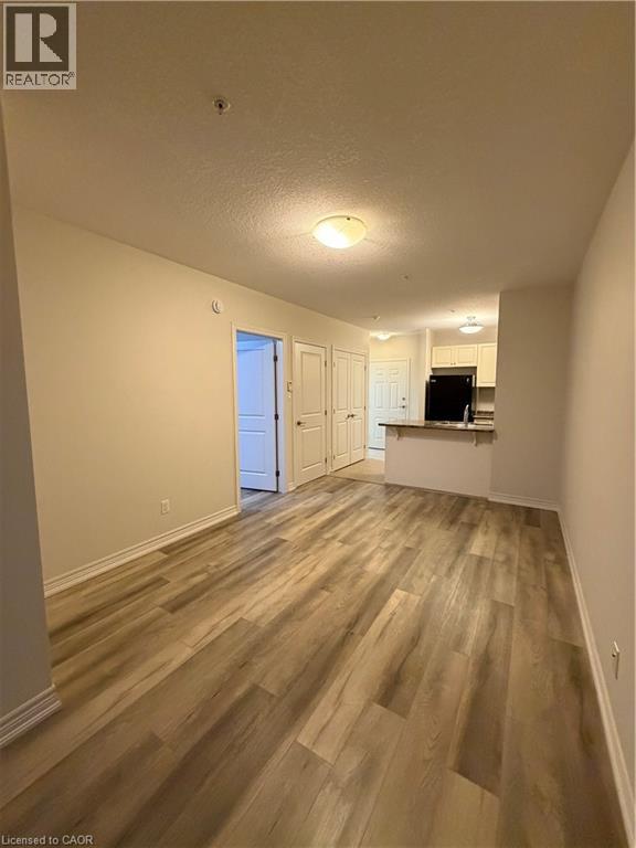 A living room with a couch, chair, and television.