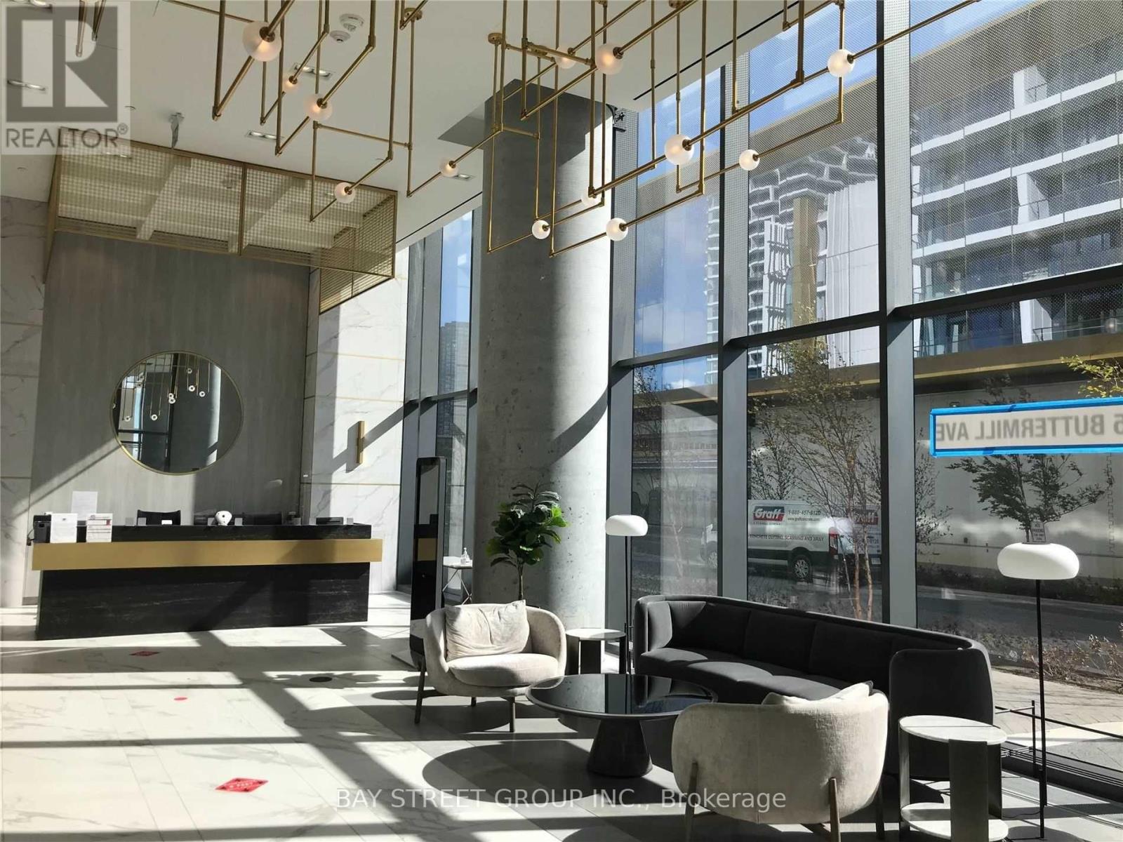 A modern waiting area with a reception desk and comfortable seating.