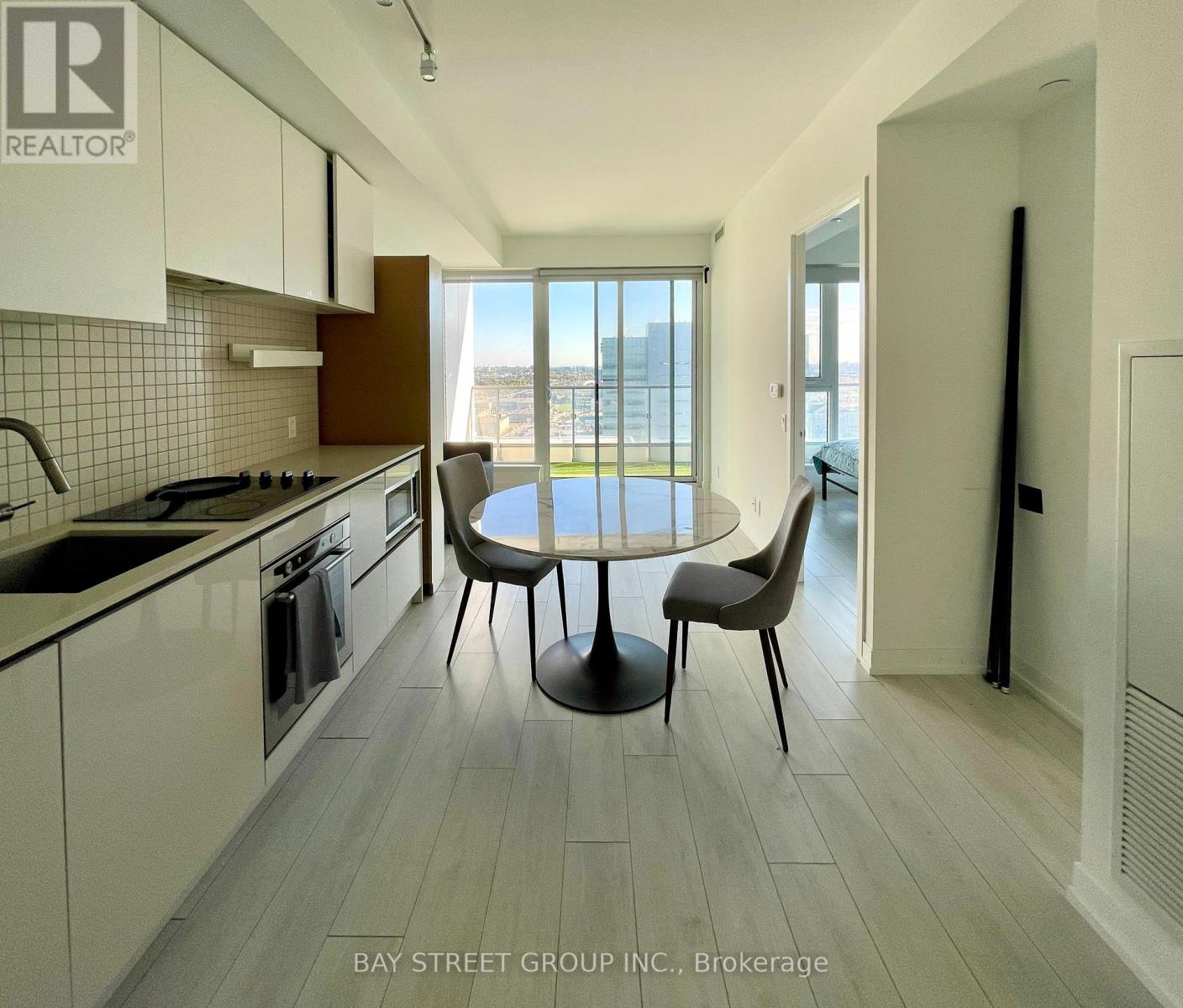 A modern kitchen with a dining table and chairs.
