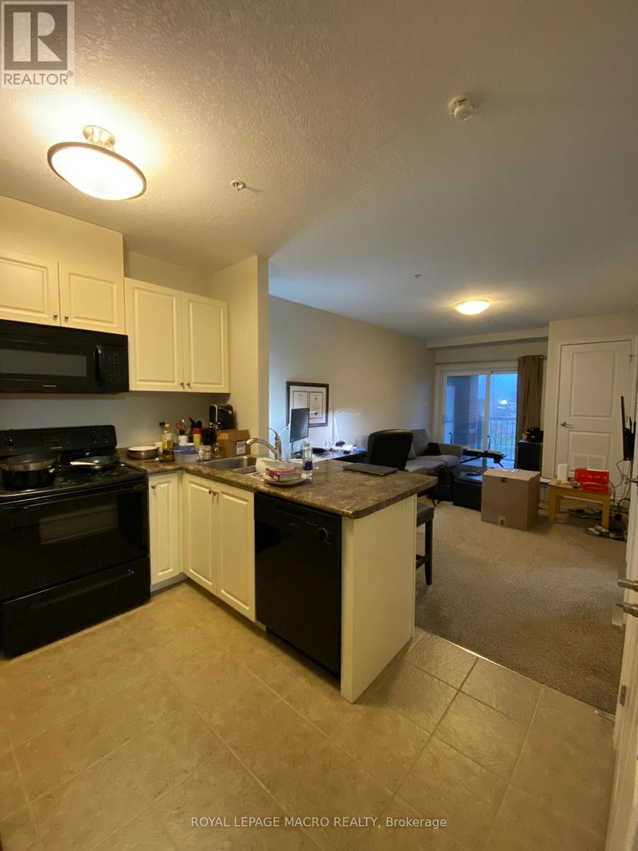 A kitchen with black appliances and white cabinets.