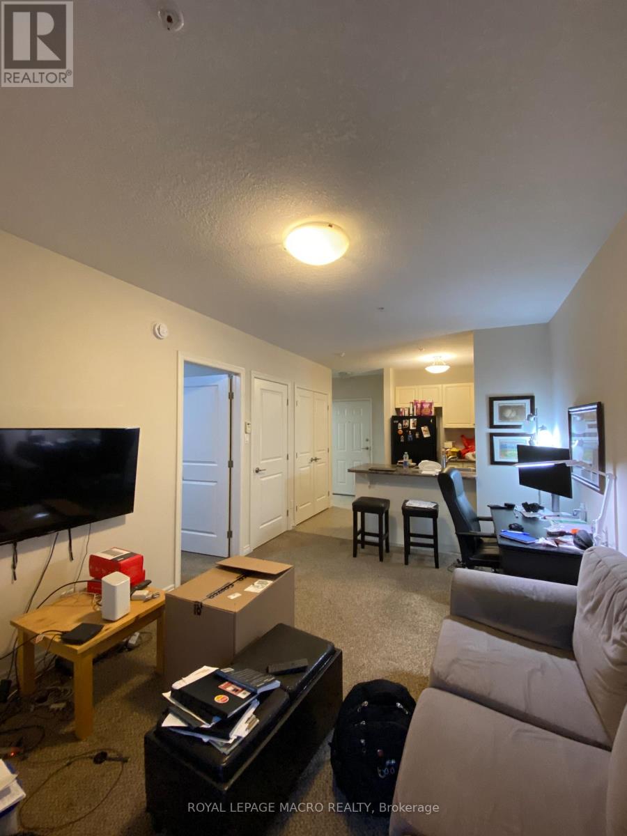 A living room with a couch, chair, and television.