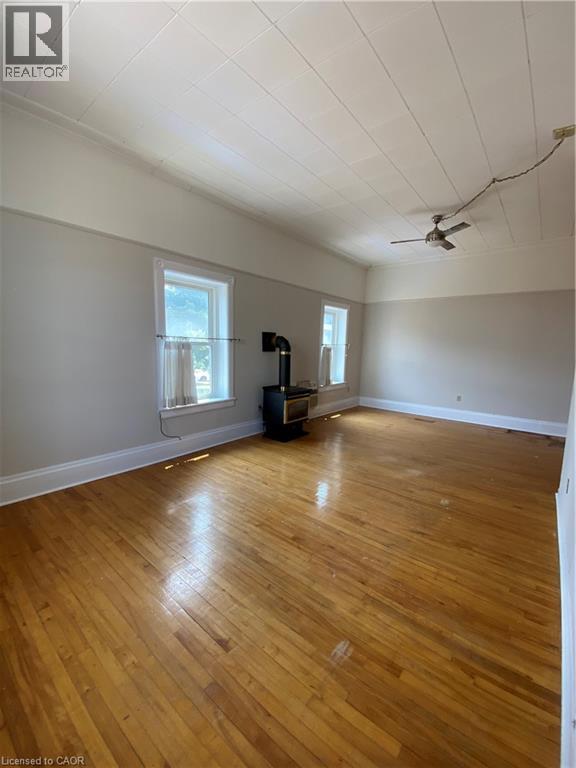 A room with wooden floors and a ceiling fan.