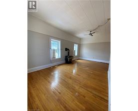 A room with wooden floors and a ceiling fan.