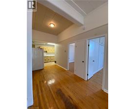 A room with wooden floors and white walls.