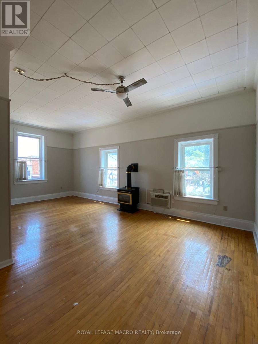 A room with wooden floors and a ceiling fan.