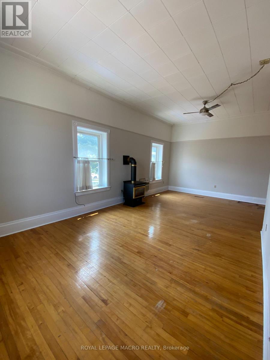 A room with wooden floors and a ceiling fan.