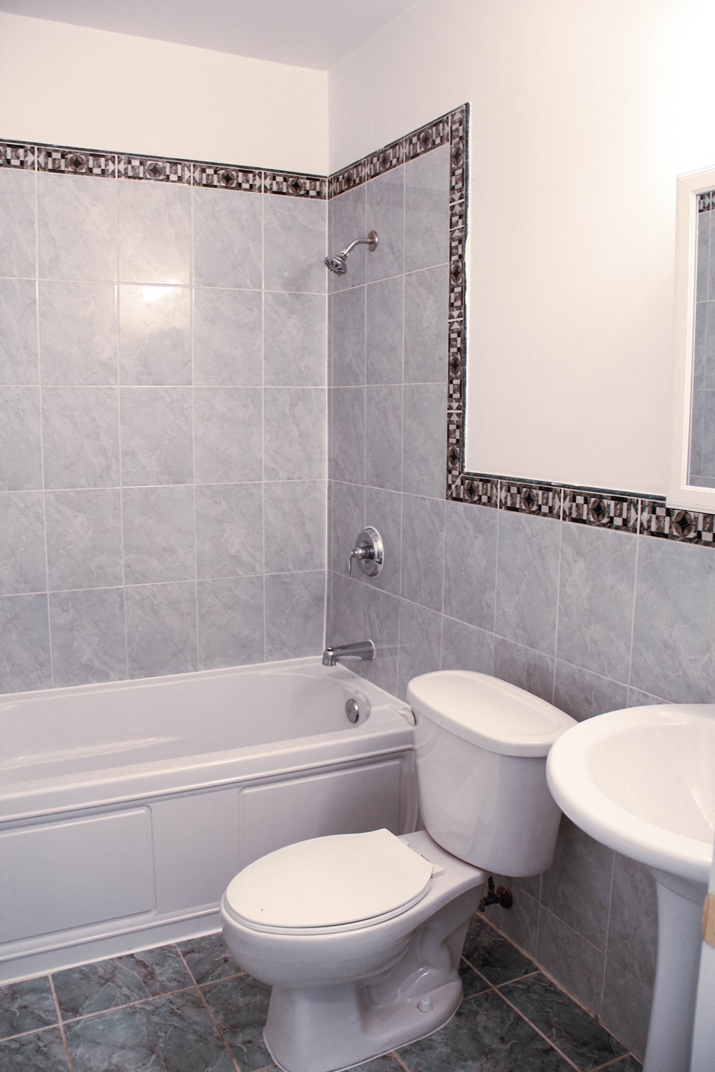 a bathroom with a toilet and a tub and a sink