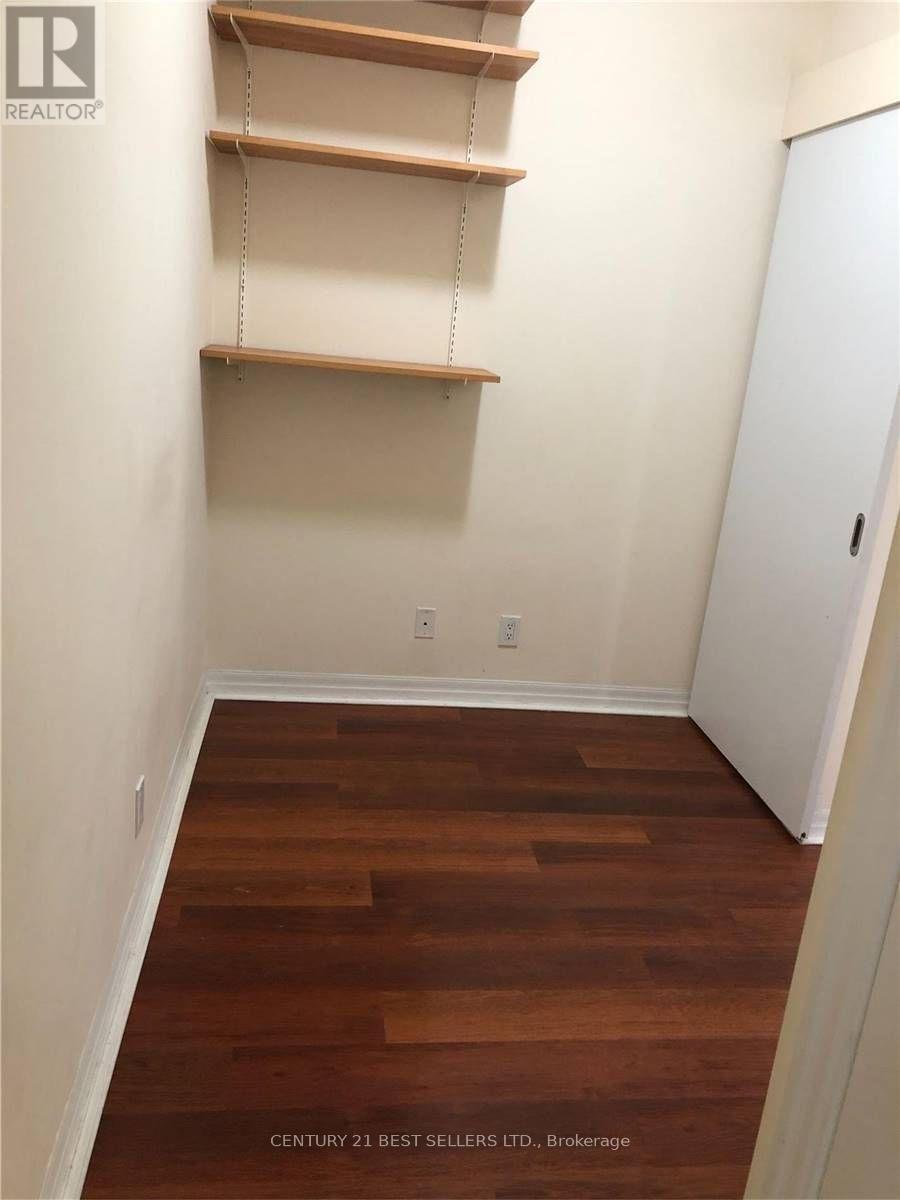 A room with wooden floors and a white door.
