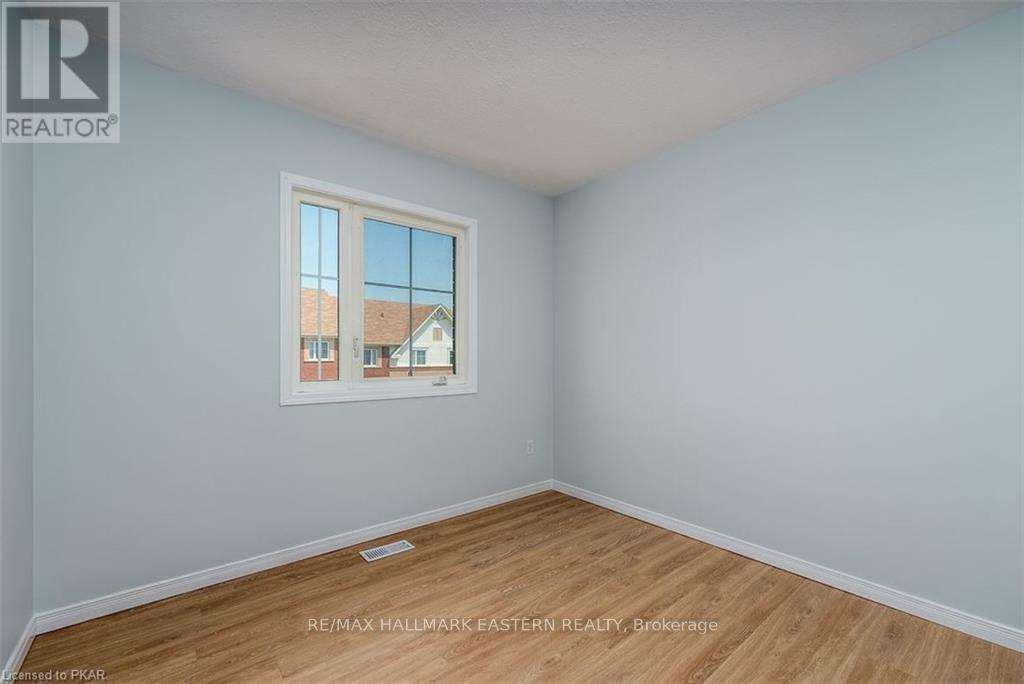 A room with a window showing a house outside.