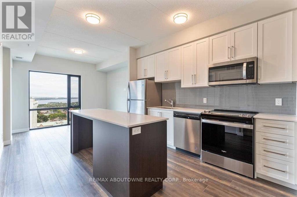 A modern kitchen with white cabinets and stainless steel appliances.