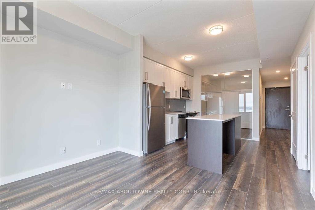 A spacious kitchen with a refrigerator, microwave, and oven.