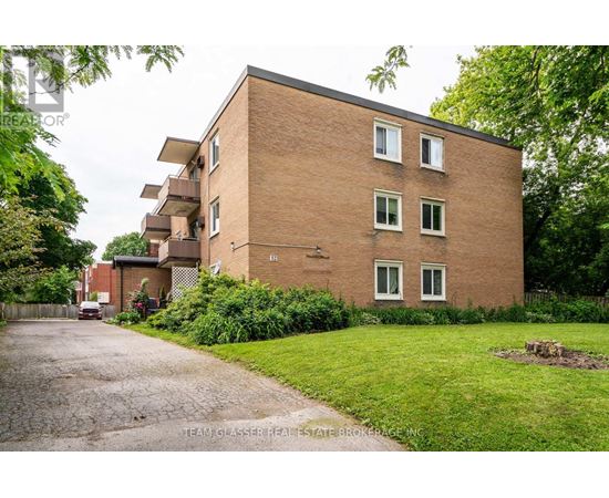 A brick building with a driveway in front of it.