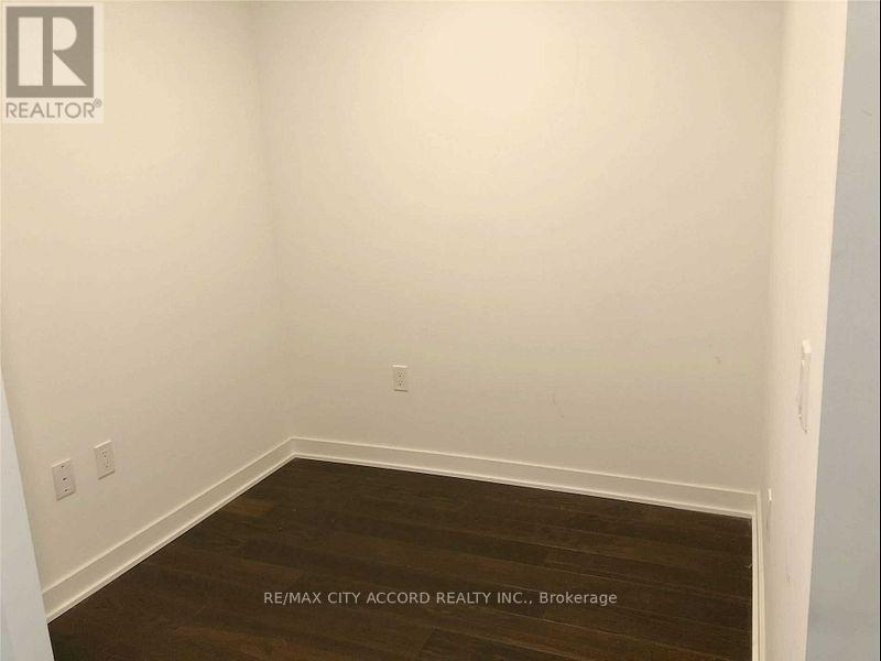 A room with a wooden floor and white walls.