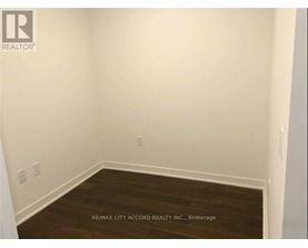 A room with a wooden floor and white walls.