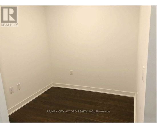 A room with a wooden floor and white walls.