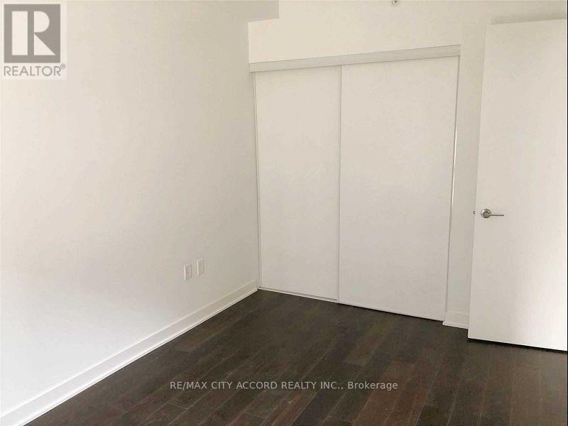 A room with a white door and a white wall.