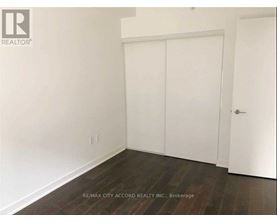 A room with a white door and a white wall.