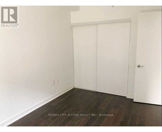 A room with a white door and a white wall.