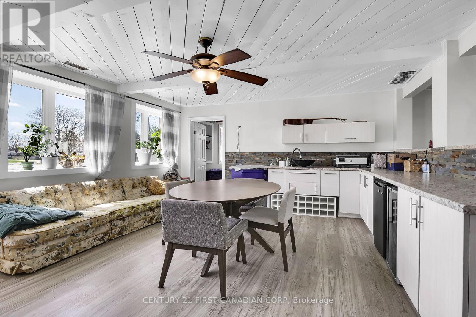A modern kitchen with a dining table and chairs.