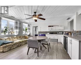 A modern kitchen with a dining table and chairs.