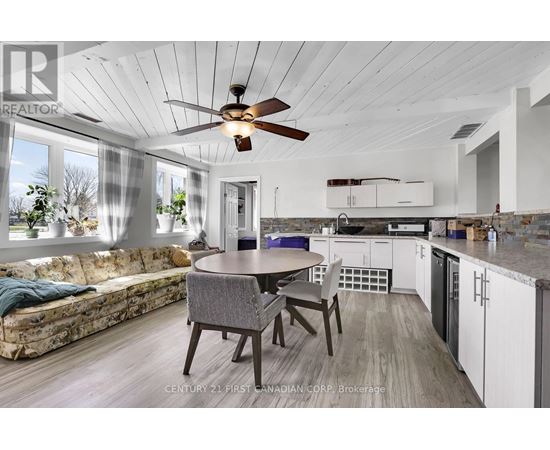 A modern kitchen with a dining table and chairs.