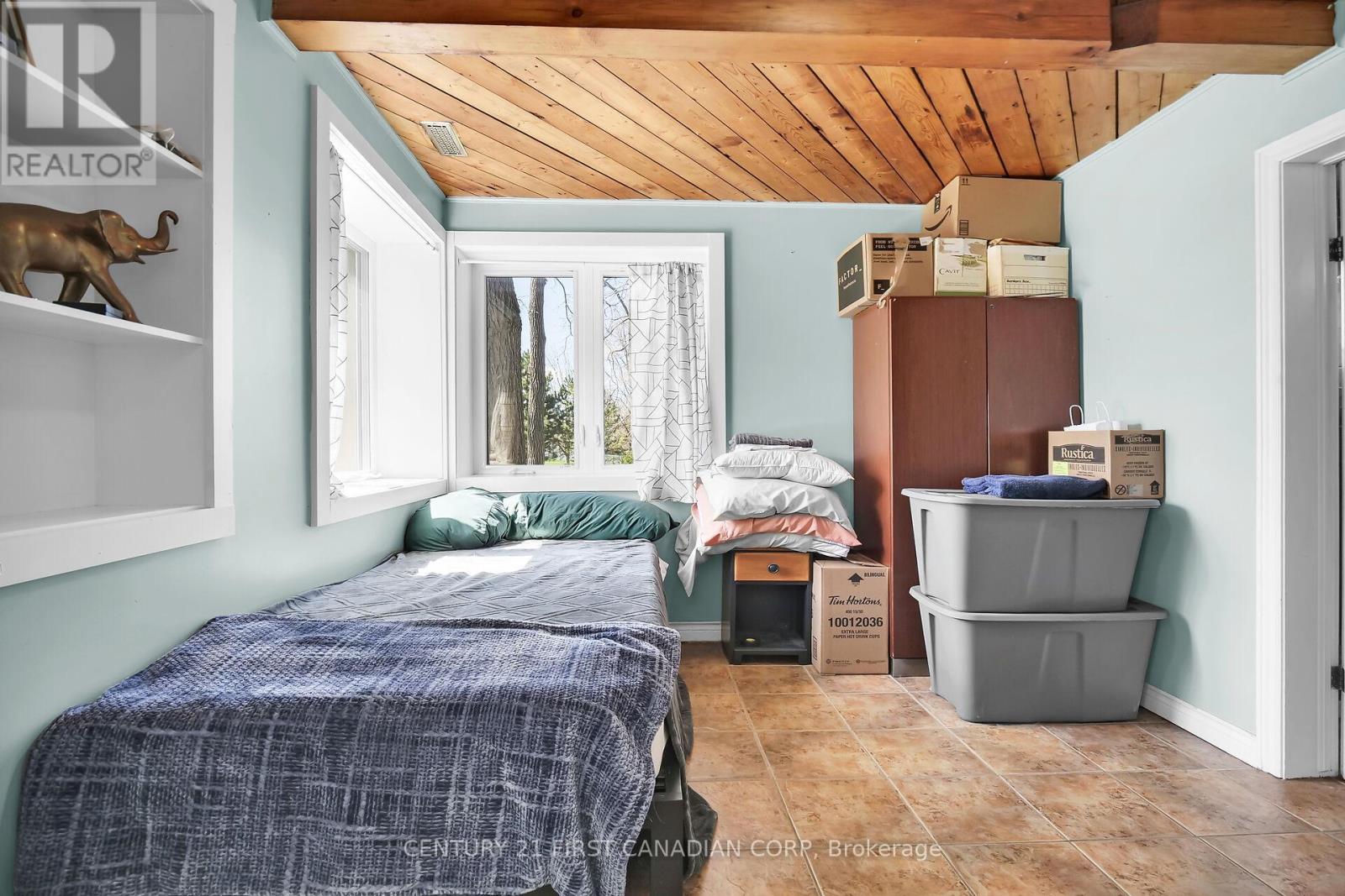 A bedroom with a bed and a window.