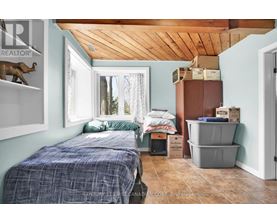 A bedroom with a bed and a window.