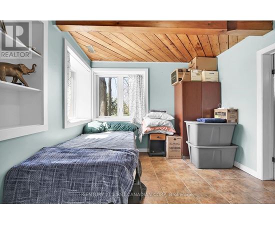 A bedroom with a bed and a window.