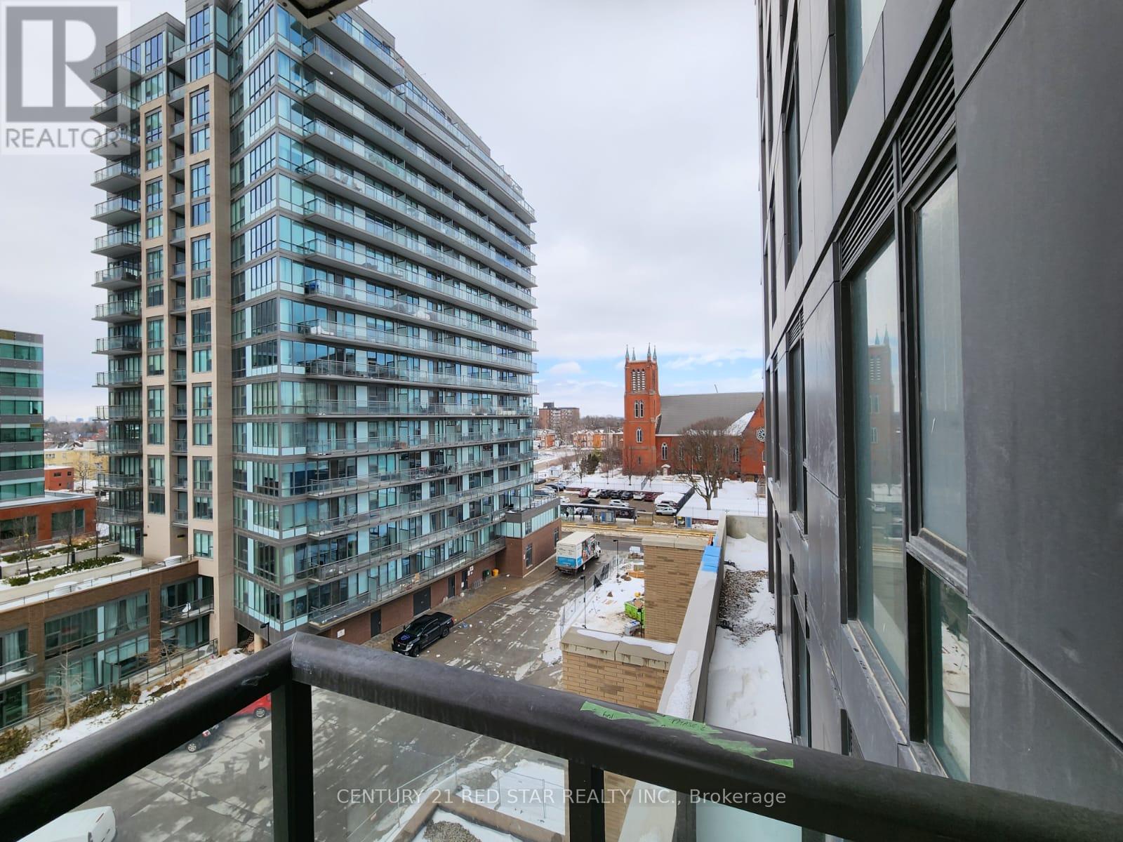 A view from a balcony of a large building with a glass facade.