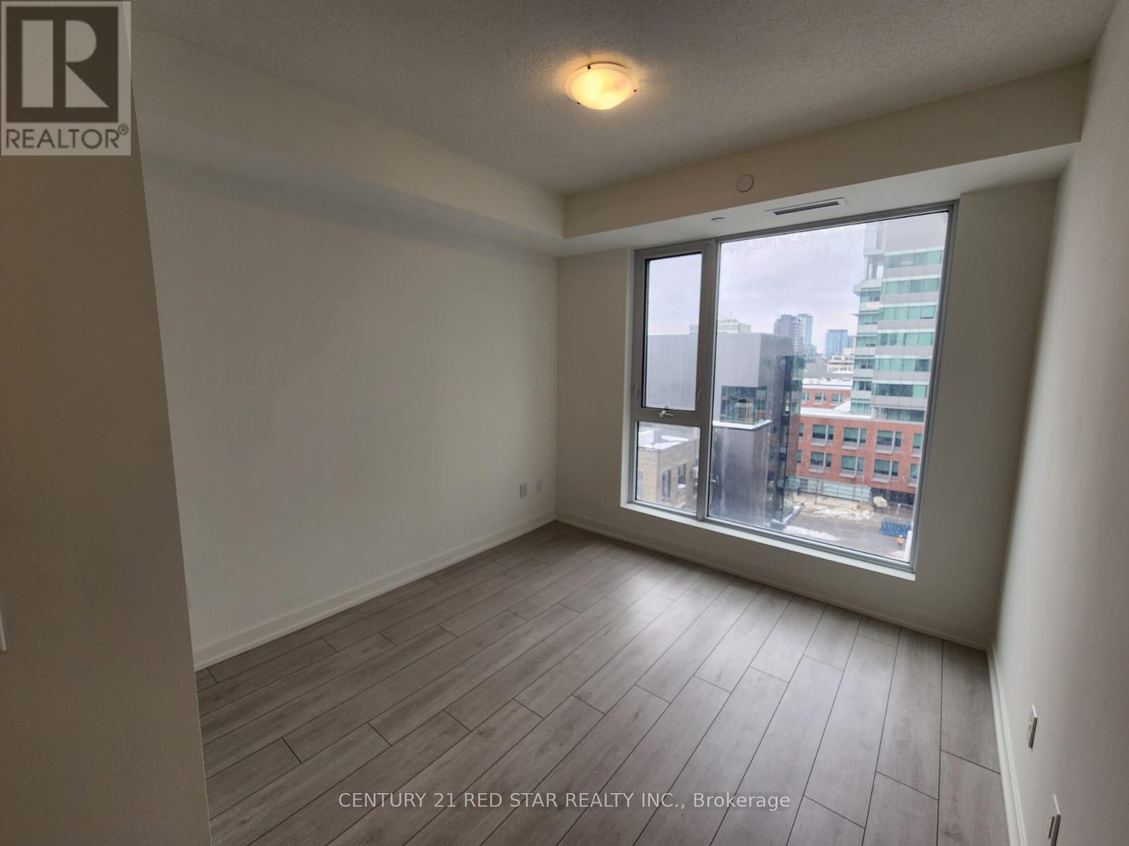 A room with a window overlooking a cityscape.